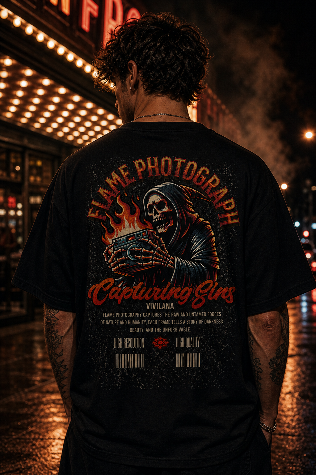 Man wearing black graphic tee with grim reaper holding camera, 'Flame Photography' design, urban night backdrop