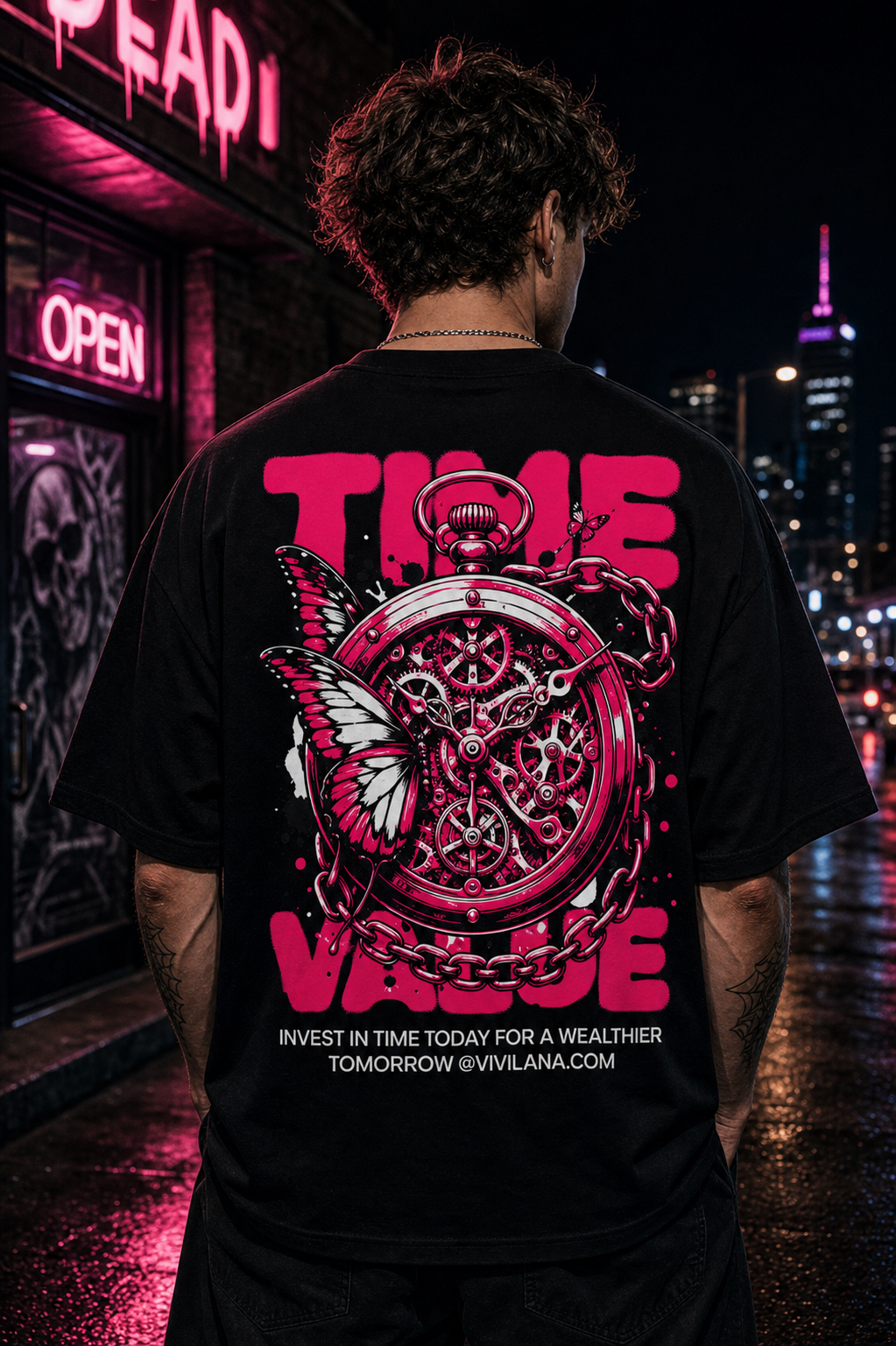 Black graphic tee with pink 'TIME VALUE' text, pocket watch, butterfly, and chain design on urban night street